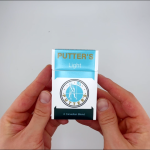 hands holding a pack of Putters Light cigarettes