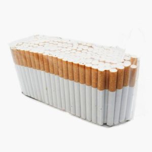 A large bundle of cigarettes arranged upright in rows, exposing brown filters and white tobacco ends, on a white background as a product display.