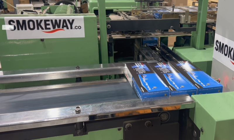 smokeway-factory-manufacturing-process-1 - Smokeway Smokeway factory, final packaging process of original native cigarettes, three cartons of Playfare's cigarettes on the conveyor