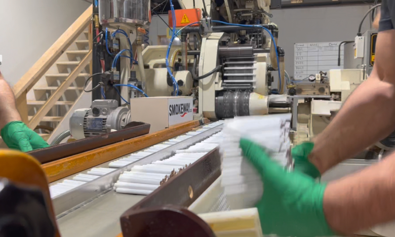 smokeway-factory-manufacturing-process-3 - Smokeway Smokeway factory, manufacturing process of original native cigarettes, pre-packaging stage, expert in gloves holding native smokes in his hand